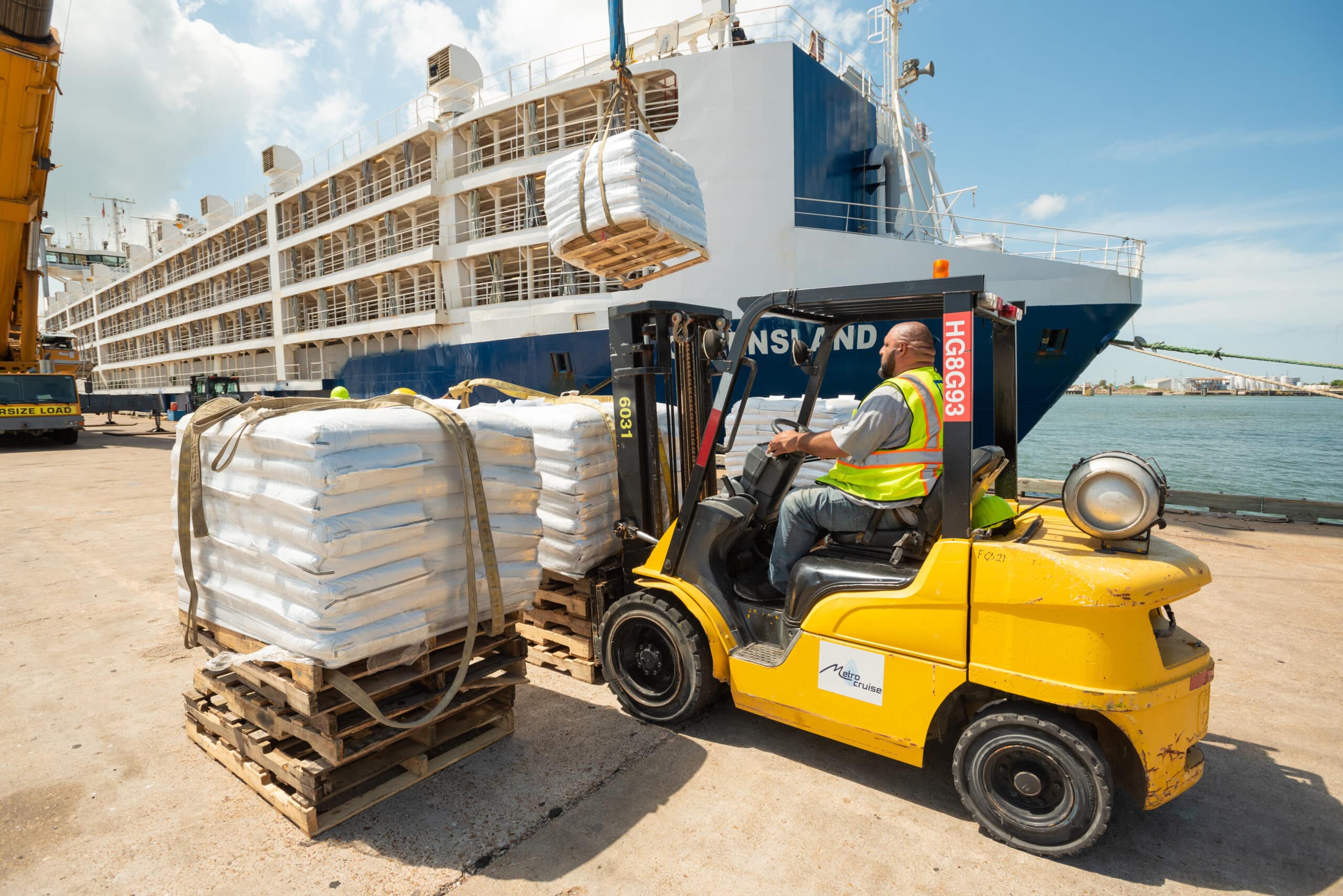 Union worker moving cargo with forklift