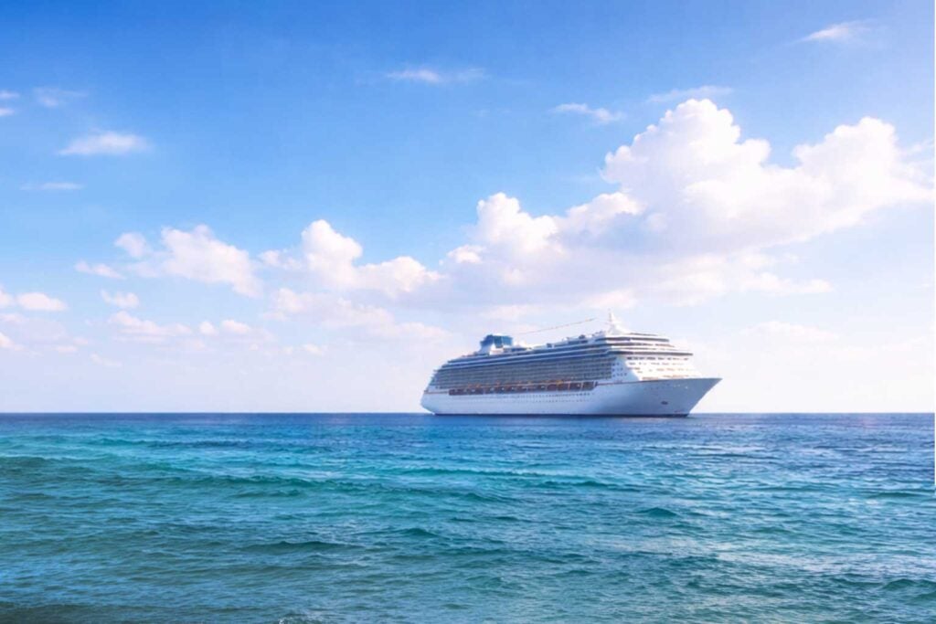 A cruise ship sailing away while cruisers enjoy the pleasant Galveston weather in February.
