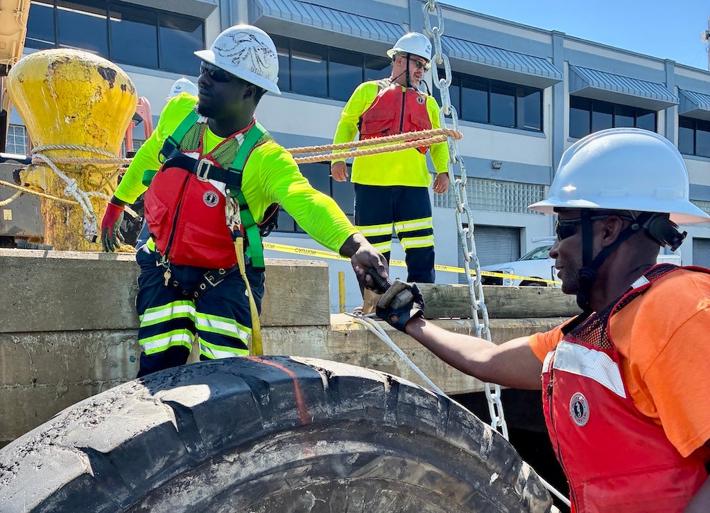 The Construction and Maintenance (C&M) team installs a new tire fender at Cruise Terminal 25.